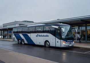 Comfortable long-distance bus at a Finnish bus station representing Matkahuolto service