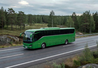Modern green intercity bus on a Finnish highway representing OnniBus service